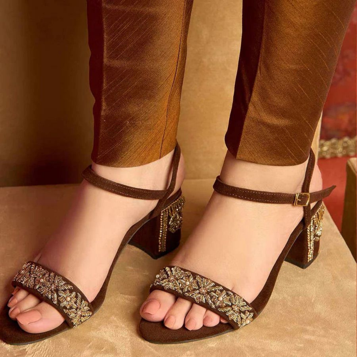 Brown ankle strap block heels worn on feet